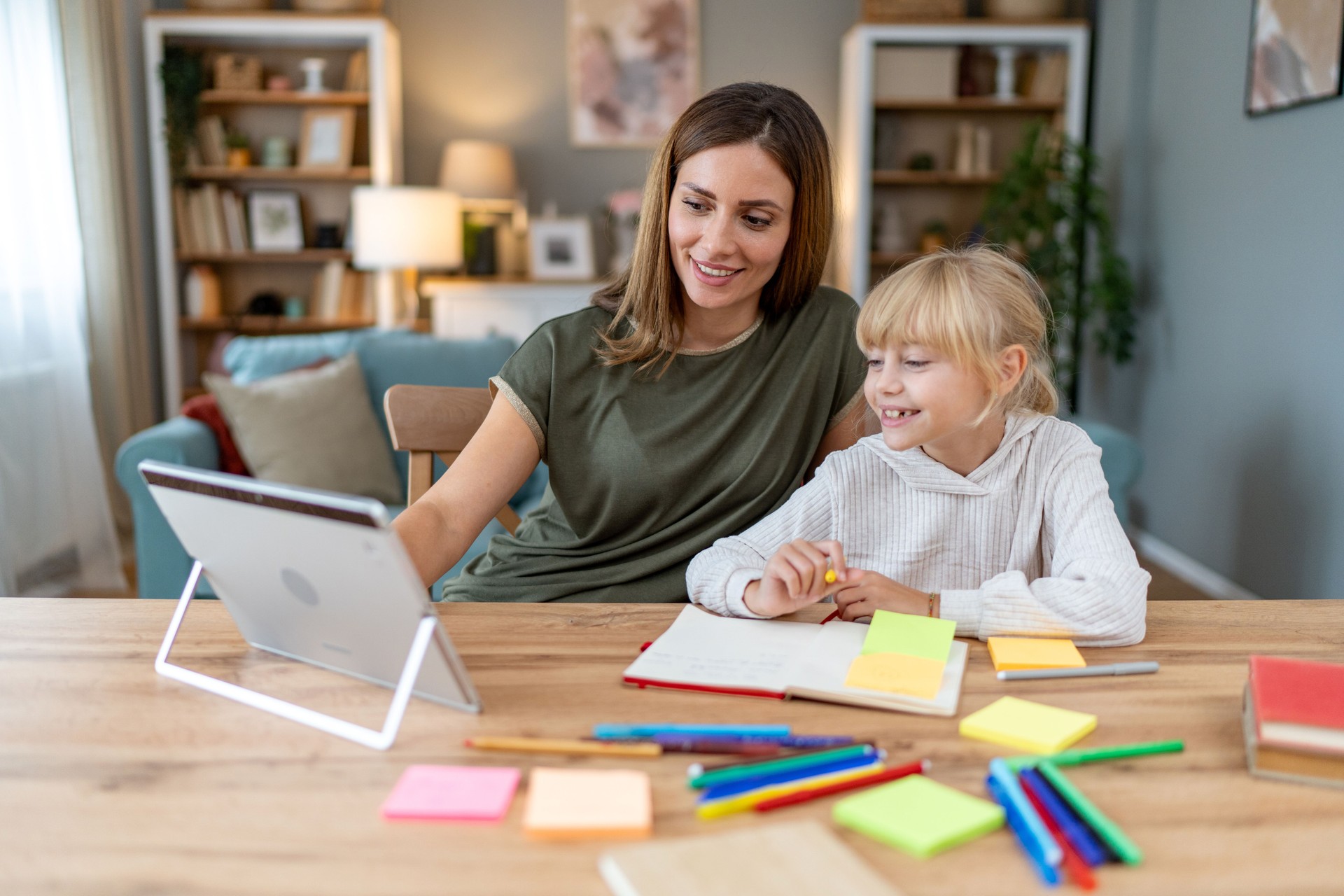 Mother is helping her little daughter to study for school